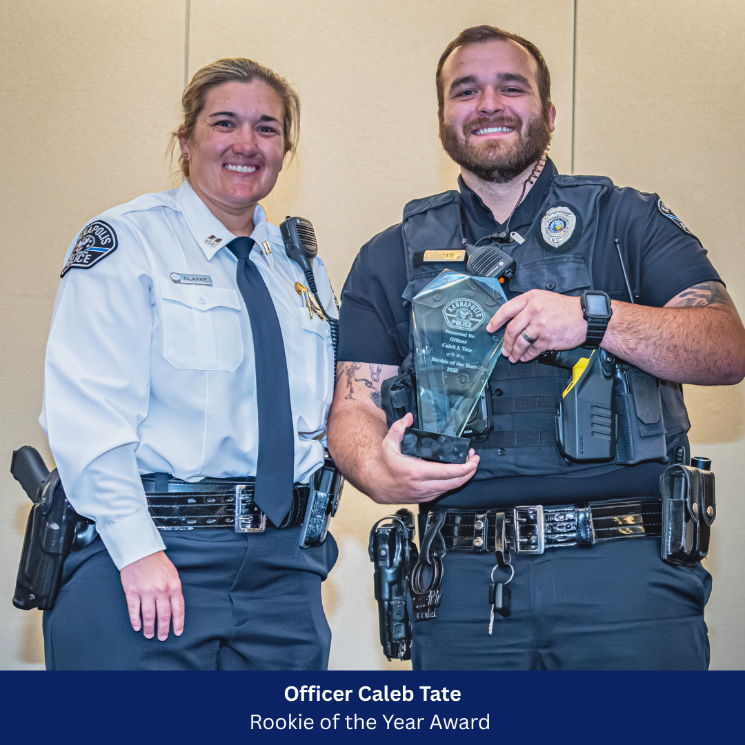 Officer Tate receiving award from Captain Clarke 